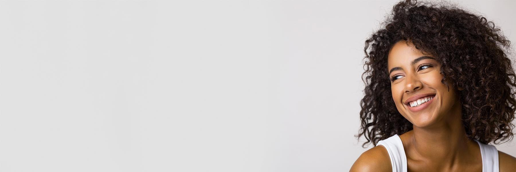 smiling woman with healthy gums in prairieville dentist office