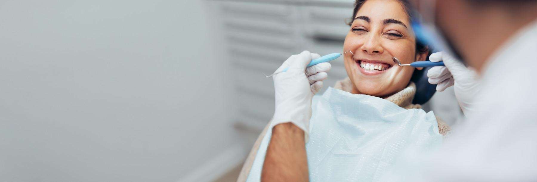 A smiling woman getting a dental exam
