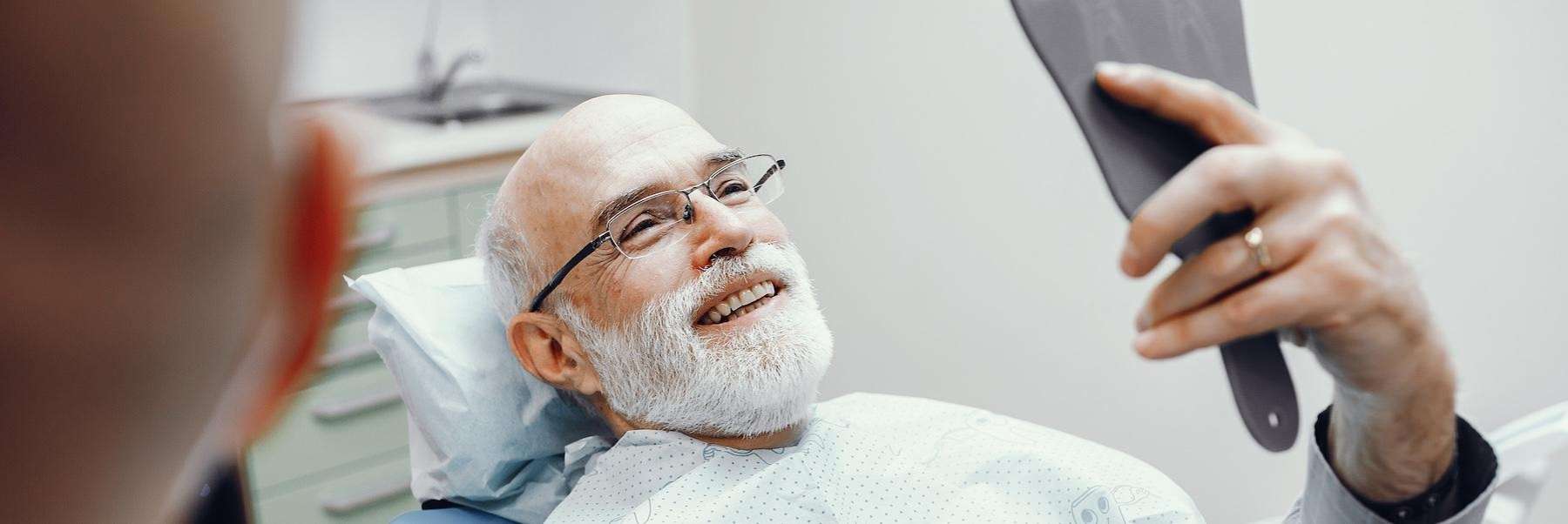 old man holding a mirror