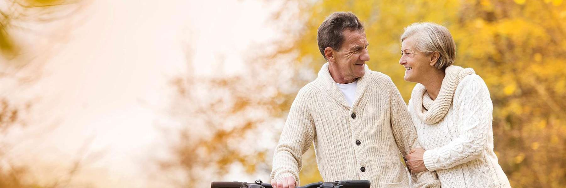 A smiling couple with a bike
