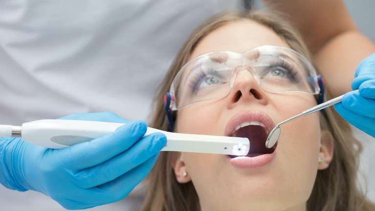 A woman receiving a dental exam | dentist Prairieville