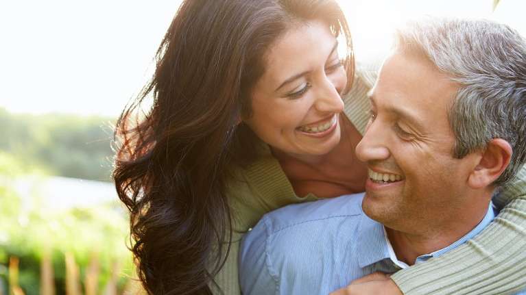 A woman hugging a man